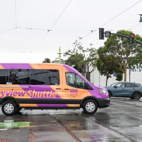 Purple and orange Bayview Shuttle van on the road