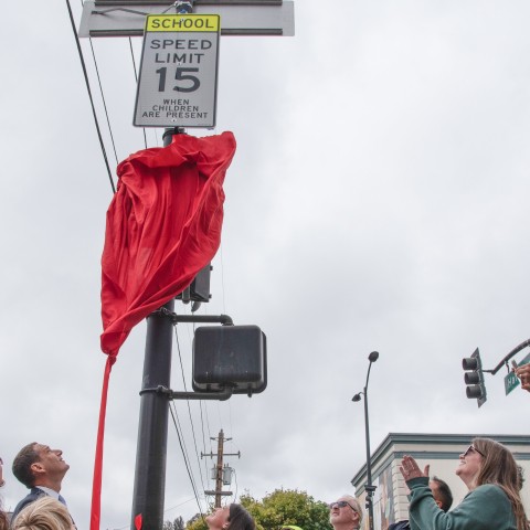 The mayor and school community unveiling new school speed limit sign