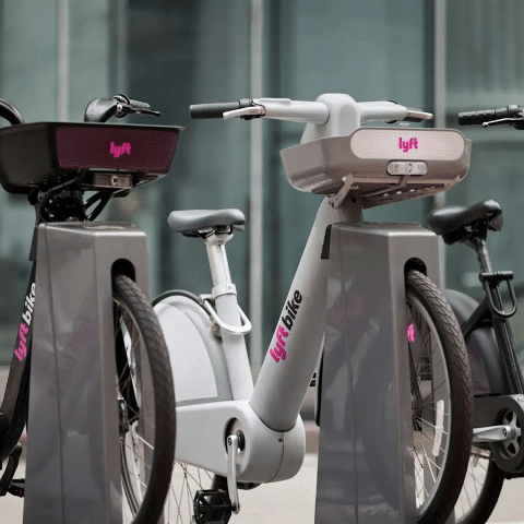 Three parked Lyft Bikes in black, gray, and black