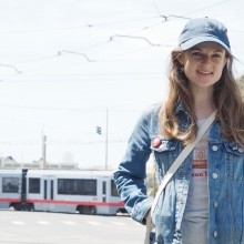 Transportation Authority Community Advisory Committee member Kat Siegal, Muni light rail vehicle in background