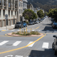 Traffic circle with plants in the middle of an four way intersection