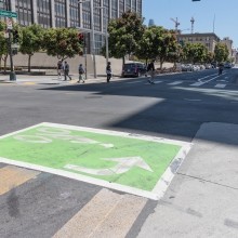 a green left turn box painted on the road 