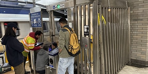 Workers install new turnstiles at the Civic Center BART station